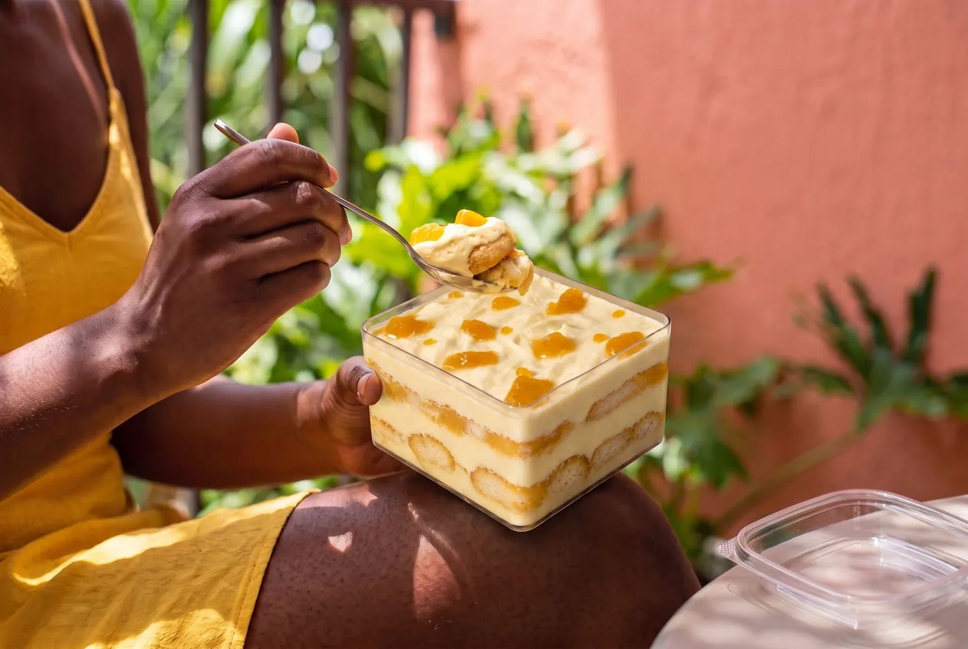Mango tiramisù eaten outdoors